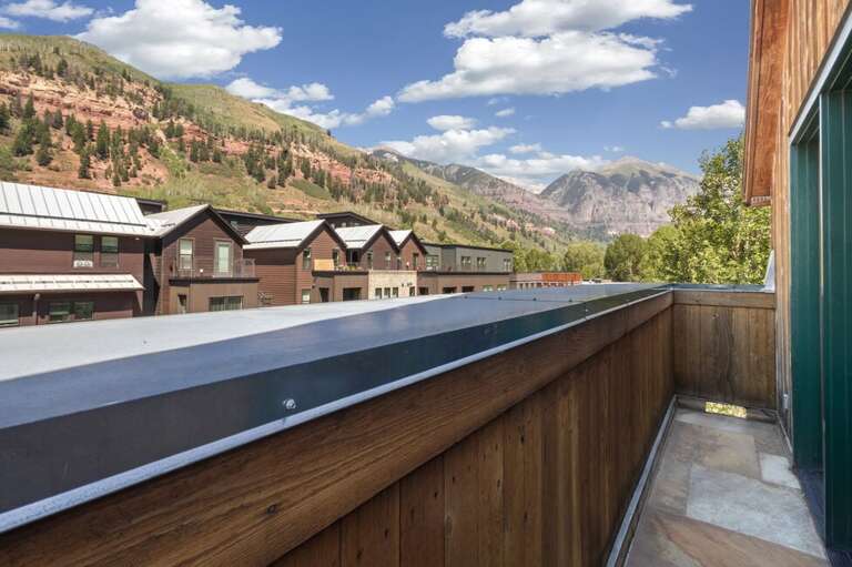 Private mini deck off the primary suite, perfect for enjoying fresh mountain air and peaceful scenic views.
