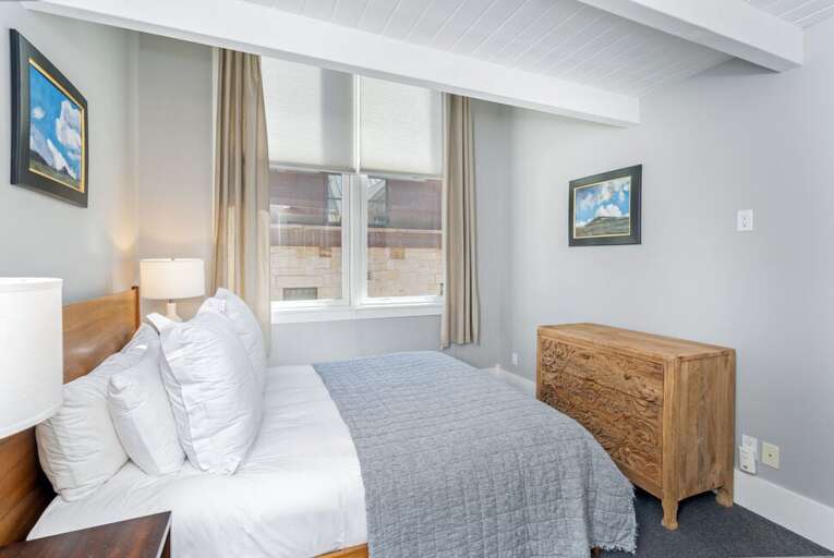 A welcoming queen guest bedroom provides a cozy and restful space for additional guests.