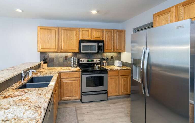 Great spacious kitchen with stainless steel appliances, electric stove and plenty of counter space.