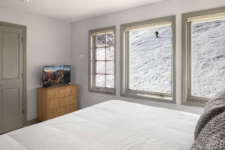 Guests can lie in bed and watch as skiers come down the mountain.
