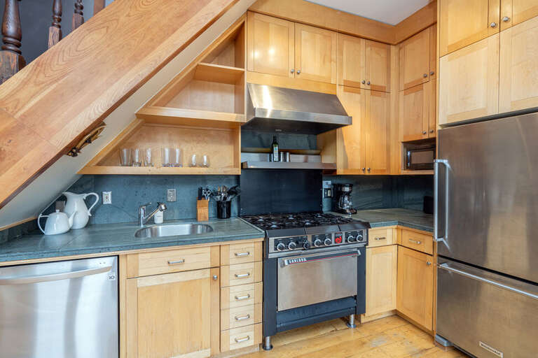Functional Kitchen with all the modern amenities, 6 burner gas stove, dishwasher and microwave.  The kitchen is stocked with all your culinary equipment .