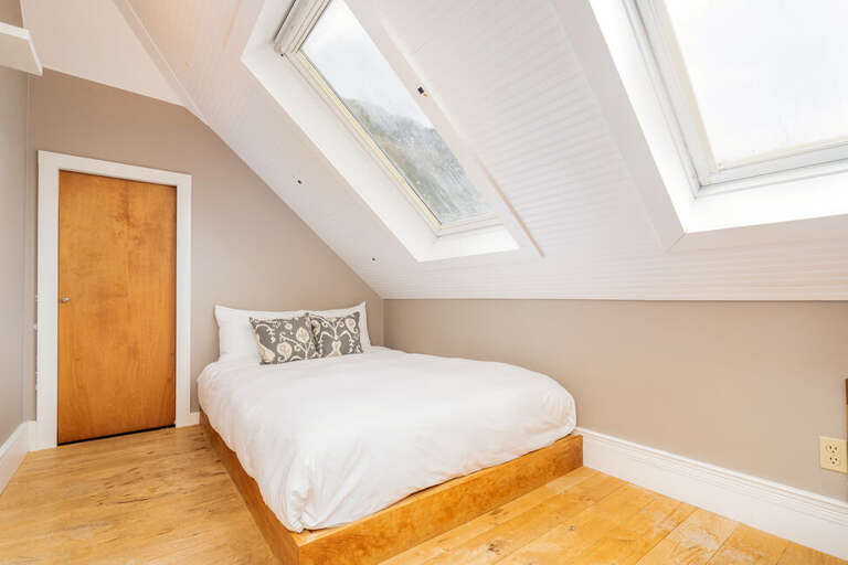 The second level features an Open loft area with plenty of natural light, spacious closet and comfy double bed.