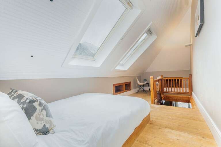 The second level features an Open loft area with plenty of natural light, spacious closet and comfy double bed.