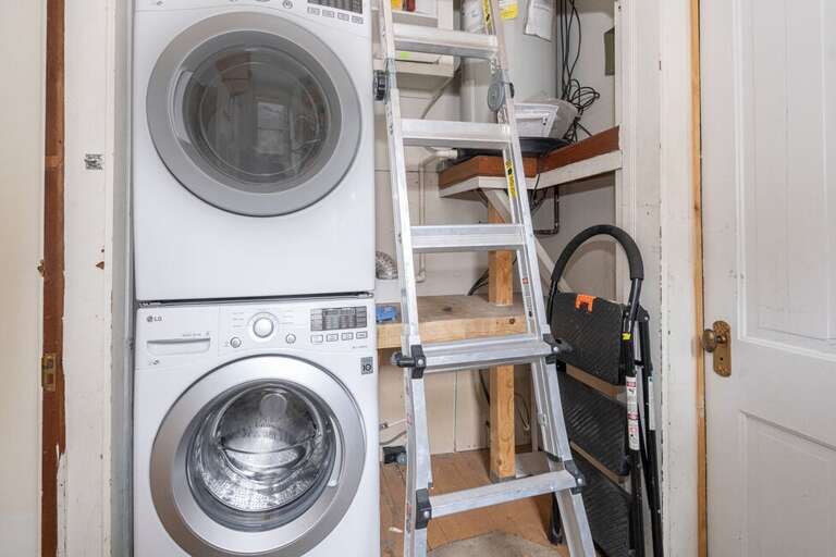 Shared laundry room is located off the primary Suite.  This area is shared with the adjoining unit and provides a stackable washer and dryer.