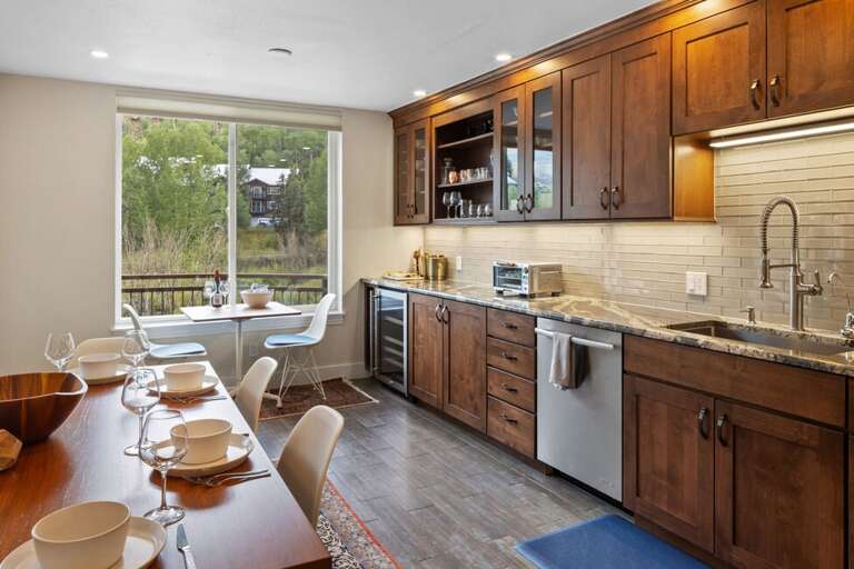 The kitchen features a seating area for 4 as well as a personal bar cart for entertaining guests.
