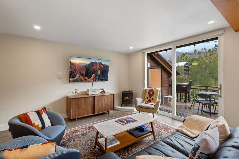 The first level opens up to a large living room, kitchen and spacious deck with plenty of natural light and a gas fireplace.