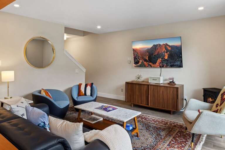 The first level opens up to a large living room, kitchen and spacious deck with plenty of natural light and a gas fireplace.