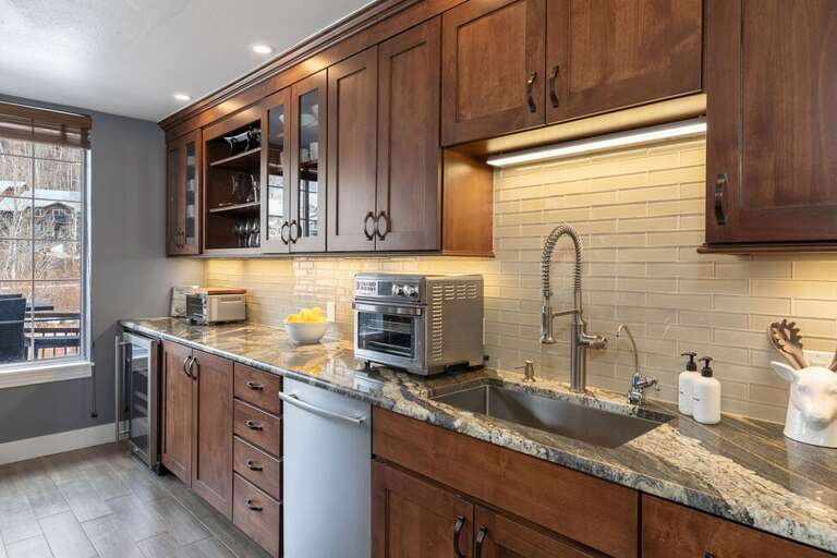 This modern gourmet kitchen is stocked with everything you would need to chef:  Toaster oven, Cuisinart Air Fryer, Breville Cappuccino machine, wine cooler. This modern gourmet kitchen is stocked with everything you would need to chef:  Toaster oven, Cuisinart Air Fryer, Breville Cappuccino machine, wine cooler.