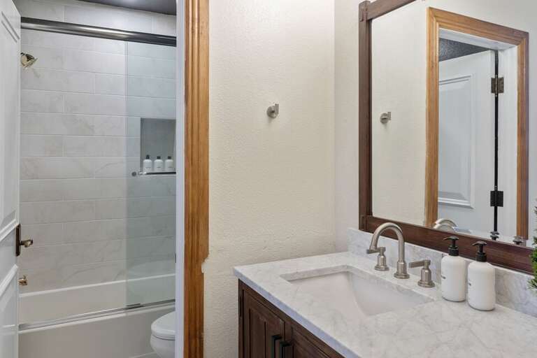 Separate bath and shower combo room.