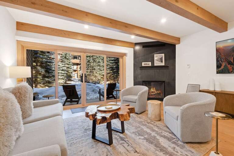 Cozy open concept family room with gas fireplace and riverfront access.