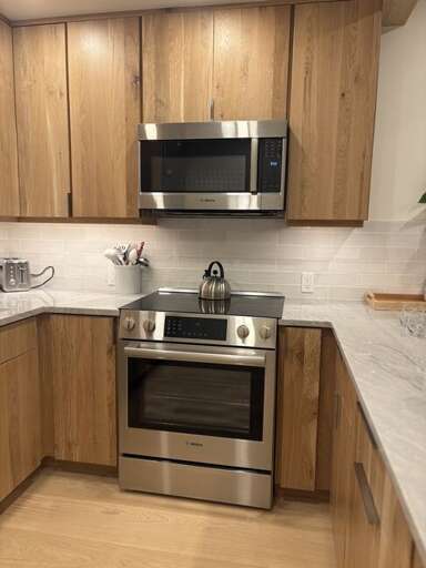 This modern kitchen features stainless appliances and everything a chef may need to create delicious meals. This modern kitchen features stainless appliances and everything a chef may need to create delicious meals.