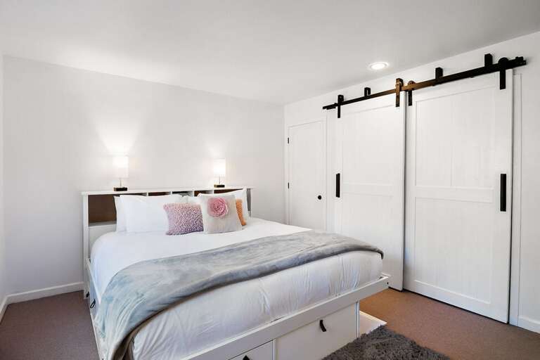 The primary bathroom features a King Bed and ensuite bathroom accessed through barn doors. The primary bathroom features a King Bed and ensuite bathroom accessed through barn doors.