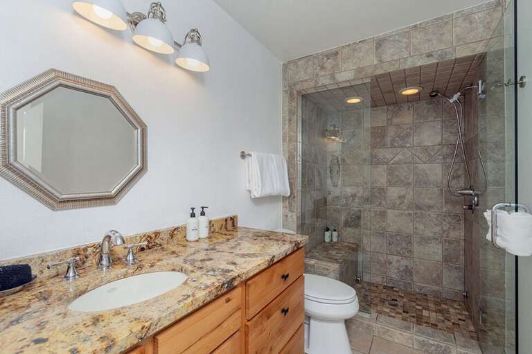 The primary ensuite bathroom features a step in shower with single vanity  and open space. The primary ensuite bathroom features a step in shower with single vanity  and open space.