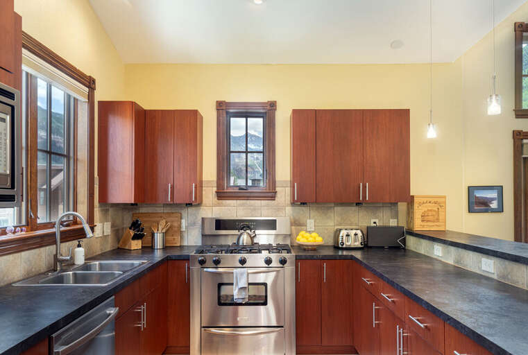 This dreamy kitchen features all stainless steel top of the line appliances:   4 burner gas stove, Side by side refrigerator, Dishwasher and microwave.