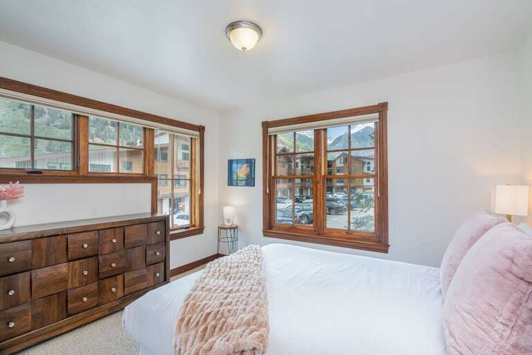Guest room two features a Green bed, large walk-in closet and stunning views of the mountains.