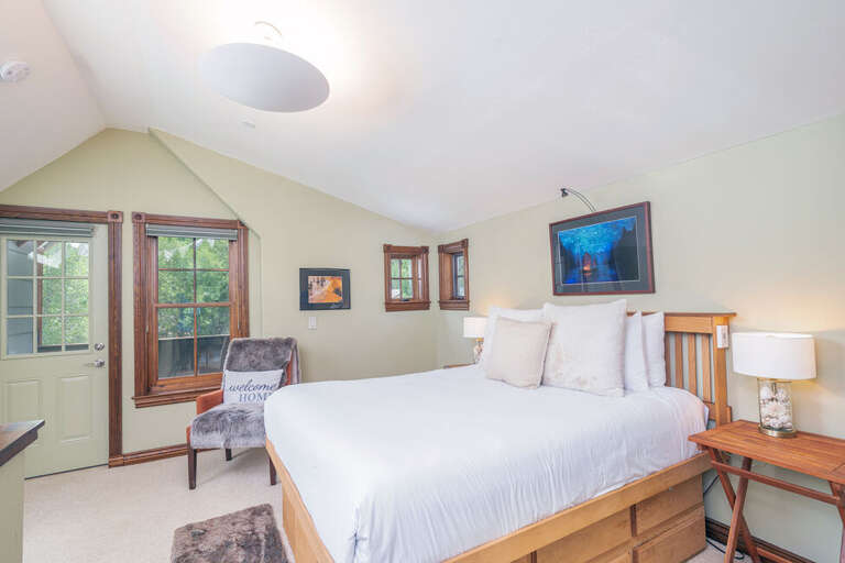 High Ceilings, private balcony and beautiful natural light make this Primary Suite the perfect place to chill after a fun day.