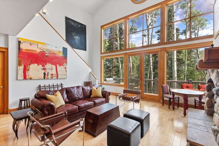 The family room features ample cozy seating, high windows that offer an astounding view of the mountains and gas fireplace to cozy up to after a fun day on the slopes.