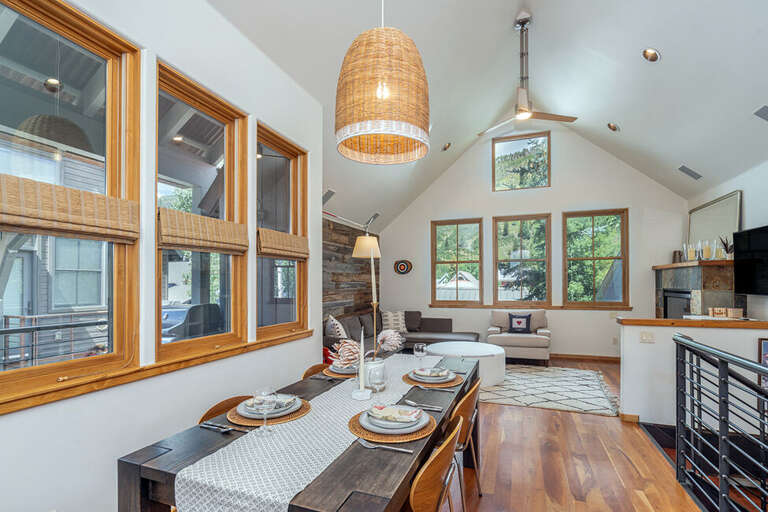 Open family room with lots of natural light, seating for four on the dining room table and gas fireplace. Open family room with lots of natural light, seating for four on the dining room table and gas fireplace.