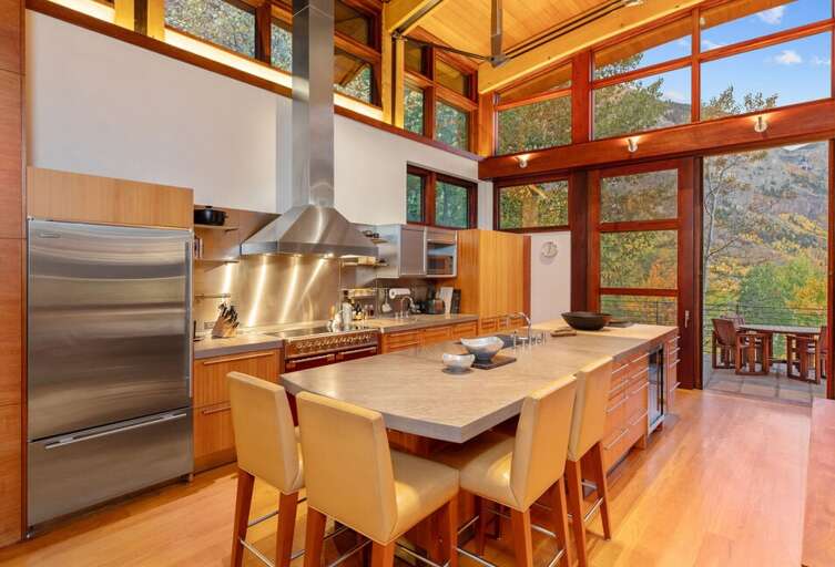 The fully-stocked gourmet kitchen is perfect for food lovers and home chefs alike, complete with high-end appliances and a wine cooler for your favorite bottles.