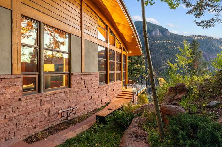 Pathways surround the house leading to different levels and porches.