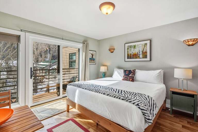 Cozy king size bed with views of the mountains.