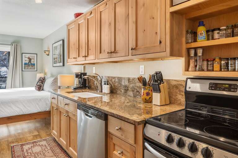 Perfect galley kitchen area with electric oven, microwave, dishwasher and full refrigerator.