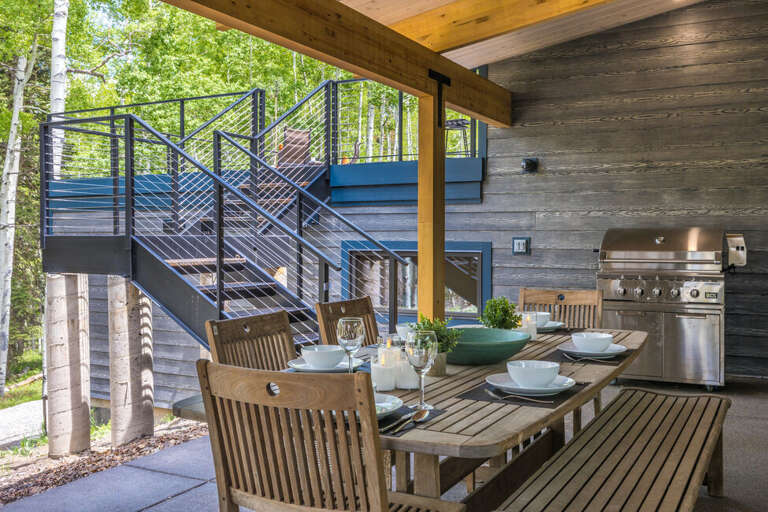 Covered outdoor dining area with gas grill and gas fireplace. Covered outdoor dining area with gas grill and gas fireplace.