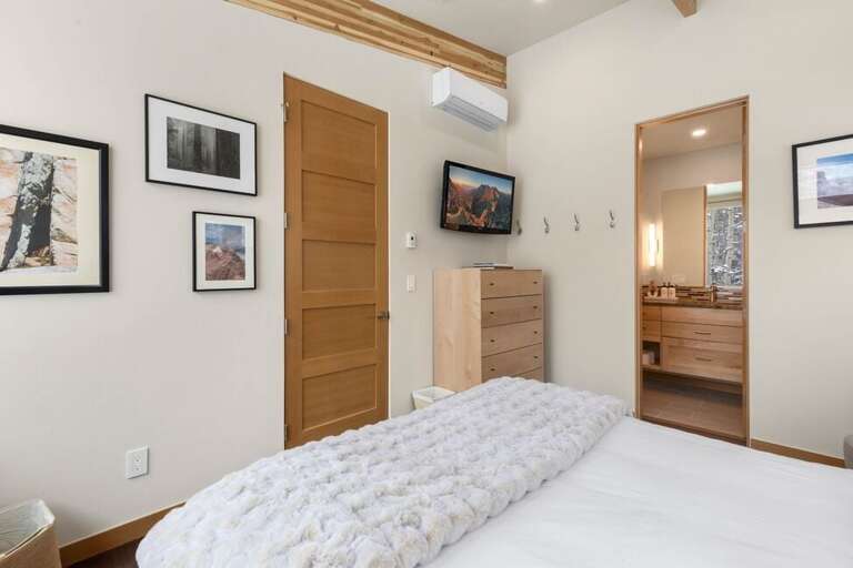 Queen size bed with ensuite bathroom located on the third level of the home. Queen size bed with ensuite bathroom located on the third level of the home.