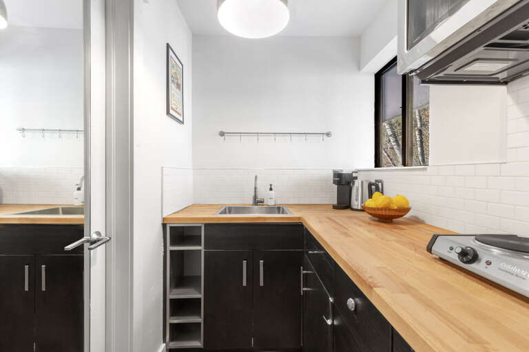 Galley kitchen clean wood counter tops.