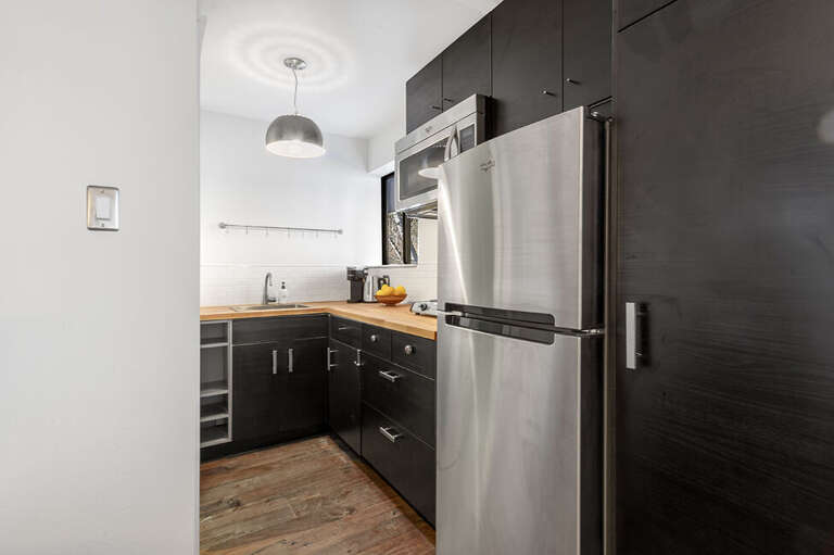 Galley Kitchen features full Refrigerator, ample storage, microwave, hot plate and coffee and kettle. Galley Kitchen features full Refrigerator, ample storage, microwave, hot plate and coffee and kettle.