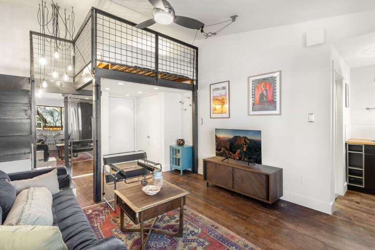 Spacious studio apartment with queen bed, cozy couch, tv, storage for gear and galley kitchen.