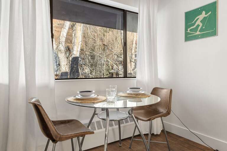 This unit Features a dining area for two with views of the local neighborhood. This unit Features a dining area for two with views of the local neighborhood.