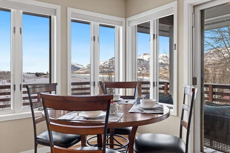 breakfast nook offers access to the back deck and grill with amazing views