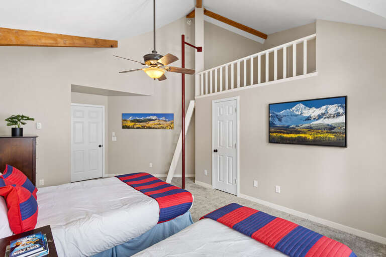 Second guest room on top level features a single bed and Queen bed with lofted area.