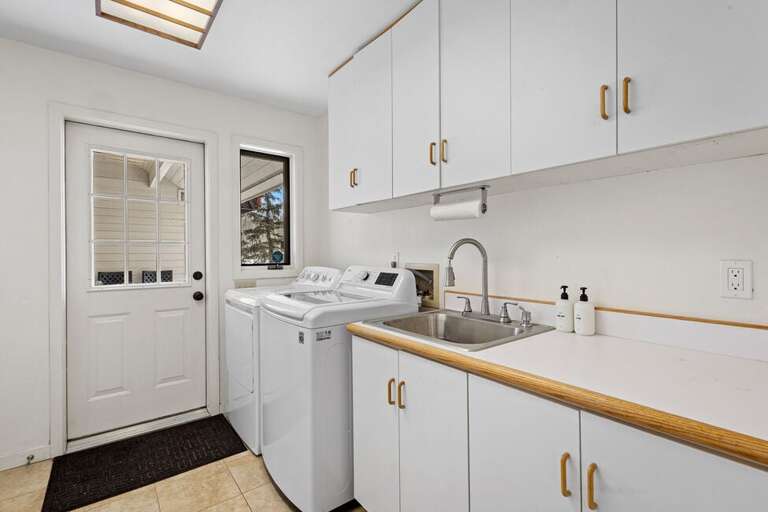 The main level off the Garage is the laundry room with access to one of the many back decks.