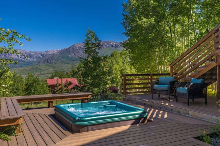 This home offers a spacious outdoor deck area with hot tub, outdoor seating, gas grill and huge open green space to explore.