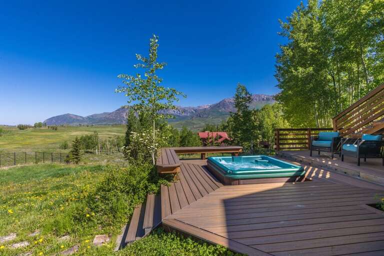 This home offers a spacious outdoor deck area with hot tub, outdoor seating, gas grill and huge open green space to explore.