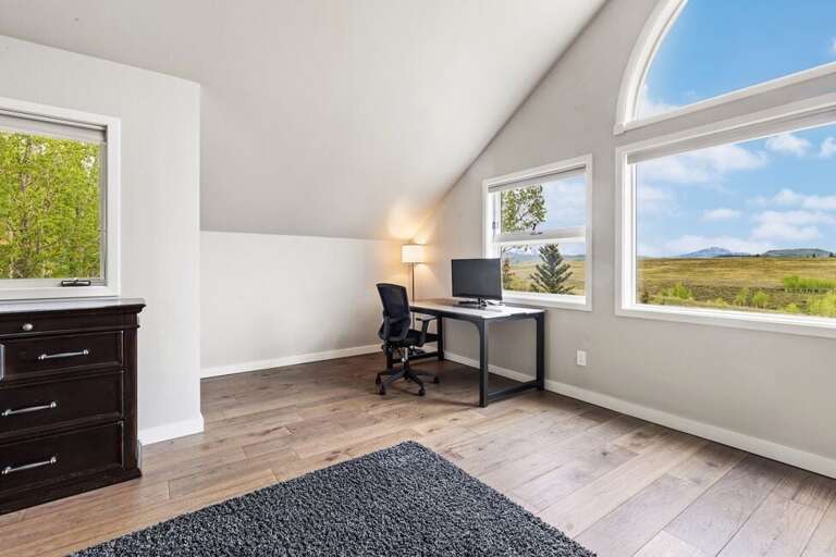 Primary Suite offers an ideal working space with computer monitor and stunning views of the mountains.