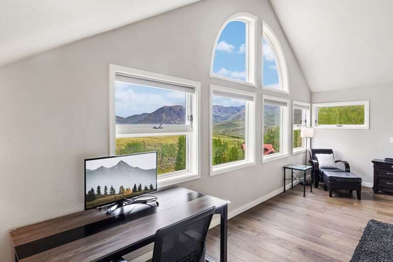 Primary Suite offers an ideal working space with computer monitor and views of the incredible mountains.