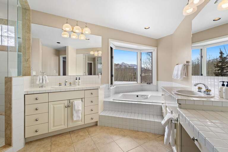 Spacious bathroom with double vanity, soaking tub, step in shower and separate water closet.