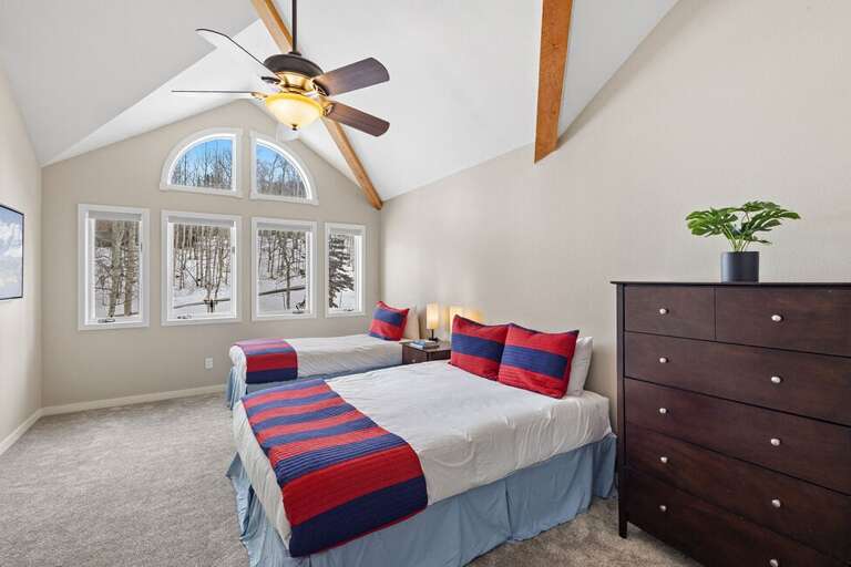 Spacious room with lofted area and single and queen bed.