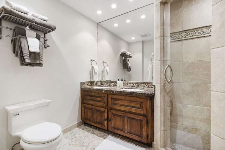 The bunk room ensuite features step in tiled shower and double vanity.