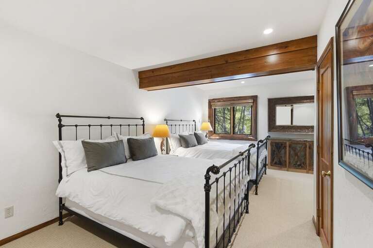 Guest Room two on the bottom level features 2 queen beds and walk in Closet.