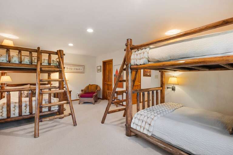 The third guest room on the bottom level is a spacious bunk room with double beds and ensuite bathroom.