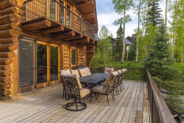 Large cozy family outdoor dining with gas grill.