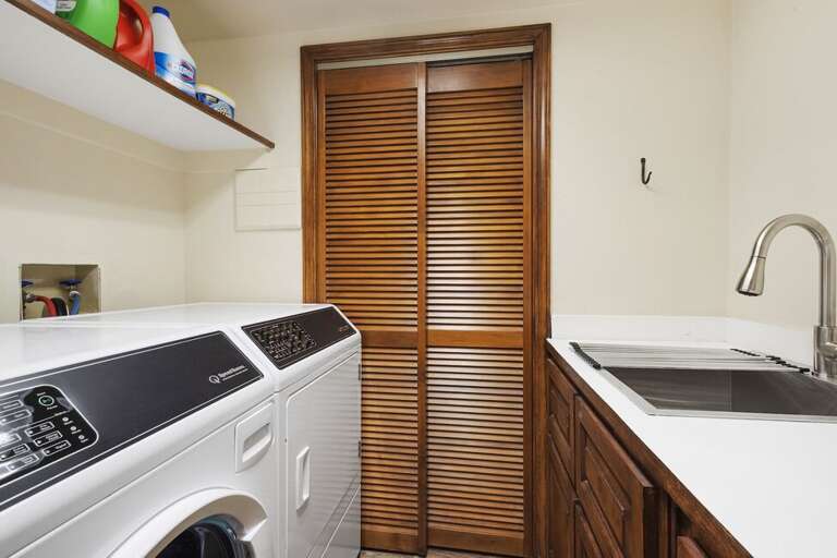Laundry Room with front loading washer and dryer and utility sink can be found on the bottom level.