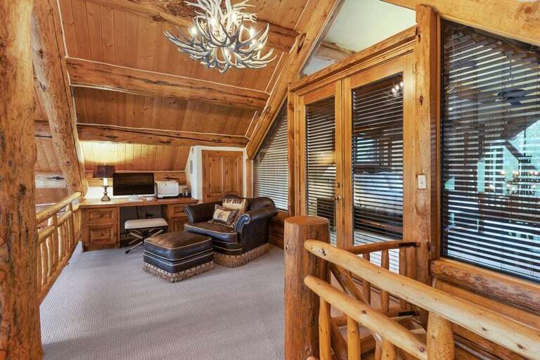 The primary suite level also features a office area with monitor and printer and overlooks the great room.