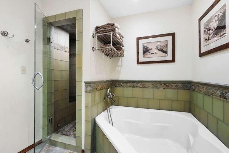 Shared bathroom on the bottom level offers a soaking tub and step in Steam shower.
