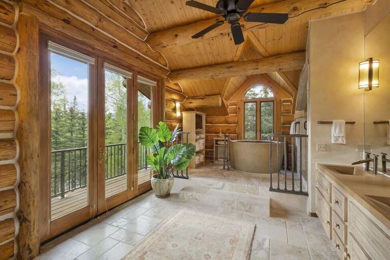 This stunning Primary Bathroom features a large steam walk-in shower, private deck and stone soaking tub.