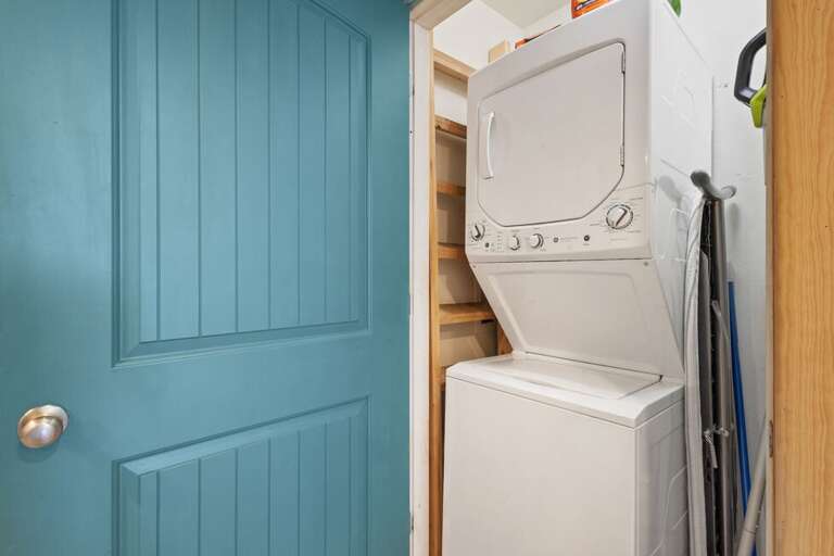 Stacked washer and dryer in unit.